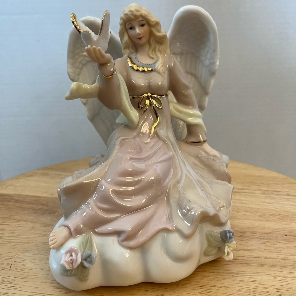 Classic Treasures Porcelain Angel Holding White Dove Musical Figurine.